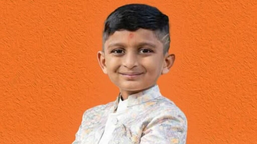 7-year-old Indian-American boy Vandan Patel, smiling in his school uniform, celebrated for being accepted into Mensa International, the world’s largest high IQ society, with aspirations of becoming a NASA astronaut and exploring Saturn’s moon Titan.